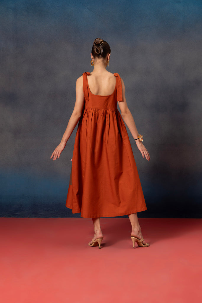 back look of Sleeveless Rust orange midi dress with brown floral patch 