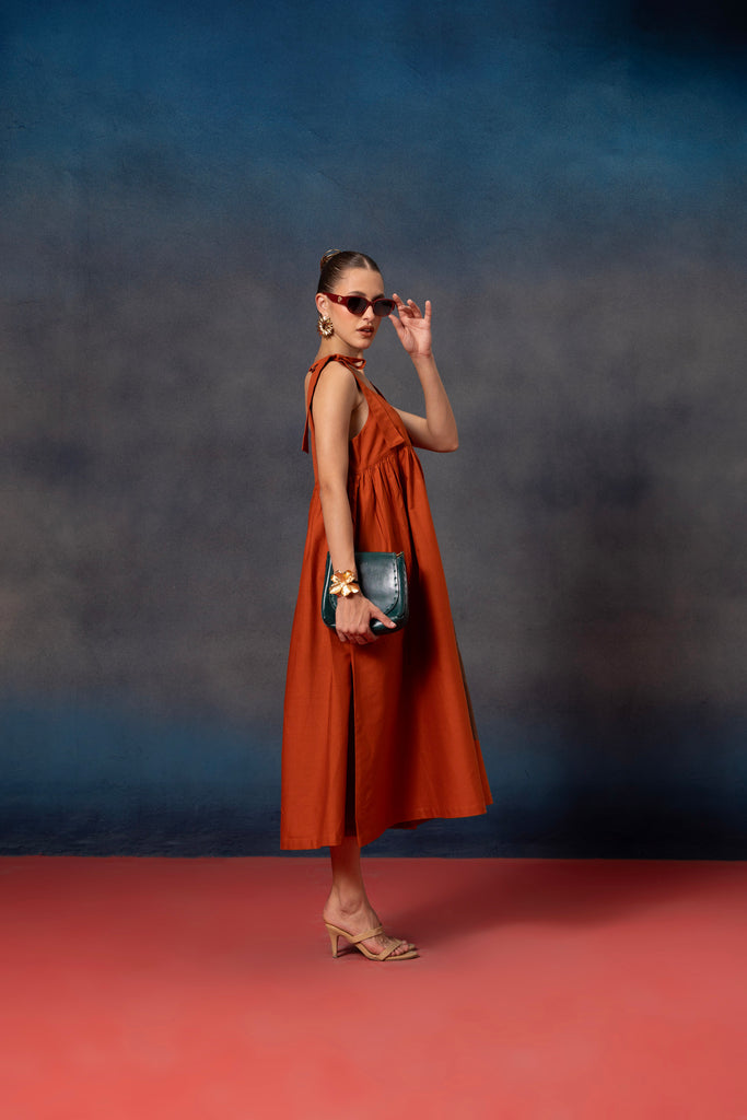 Sleeveless Rust orange midi dress with brown floral patch on it 