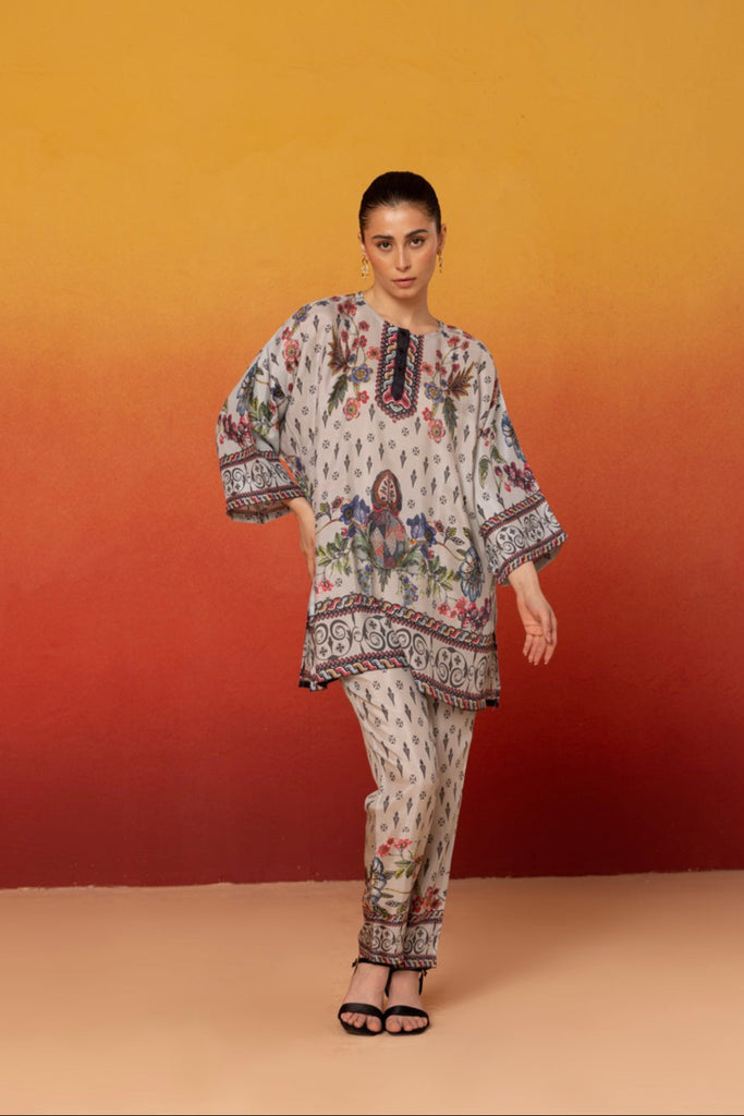 Light grey coordinating set with multi color floral print and geometric patterns, consisting of a top and pants